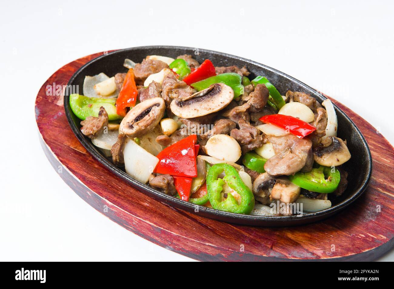 Asian beef with red peppers and mushrooms at a Korean restaurant. White