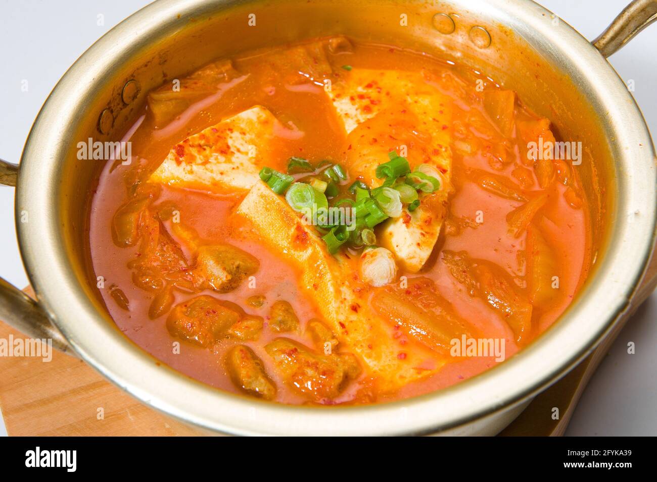 Asian tofu in a spicy kimchi sauce at a Korean restaurant.  White background. Stock Photo