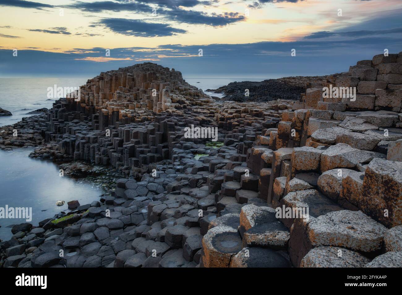 Sunset at the Giant's causeway in County Antrim on the northeast coast of Northern Ireland. Stock Photo