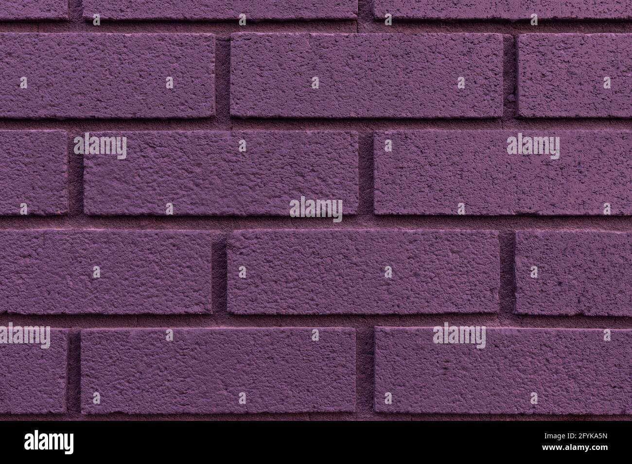 Close up of painted purple brick wall texture background. Stock Photo