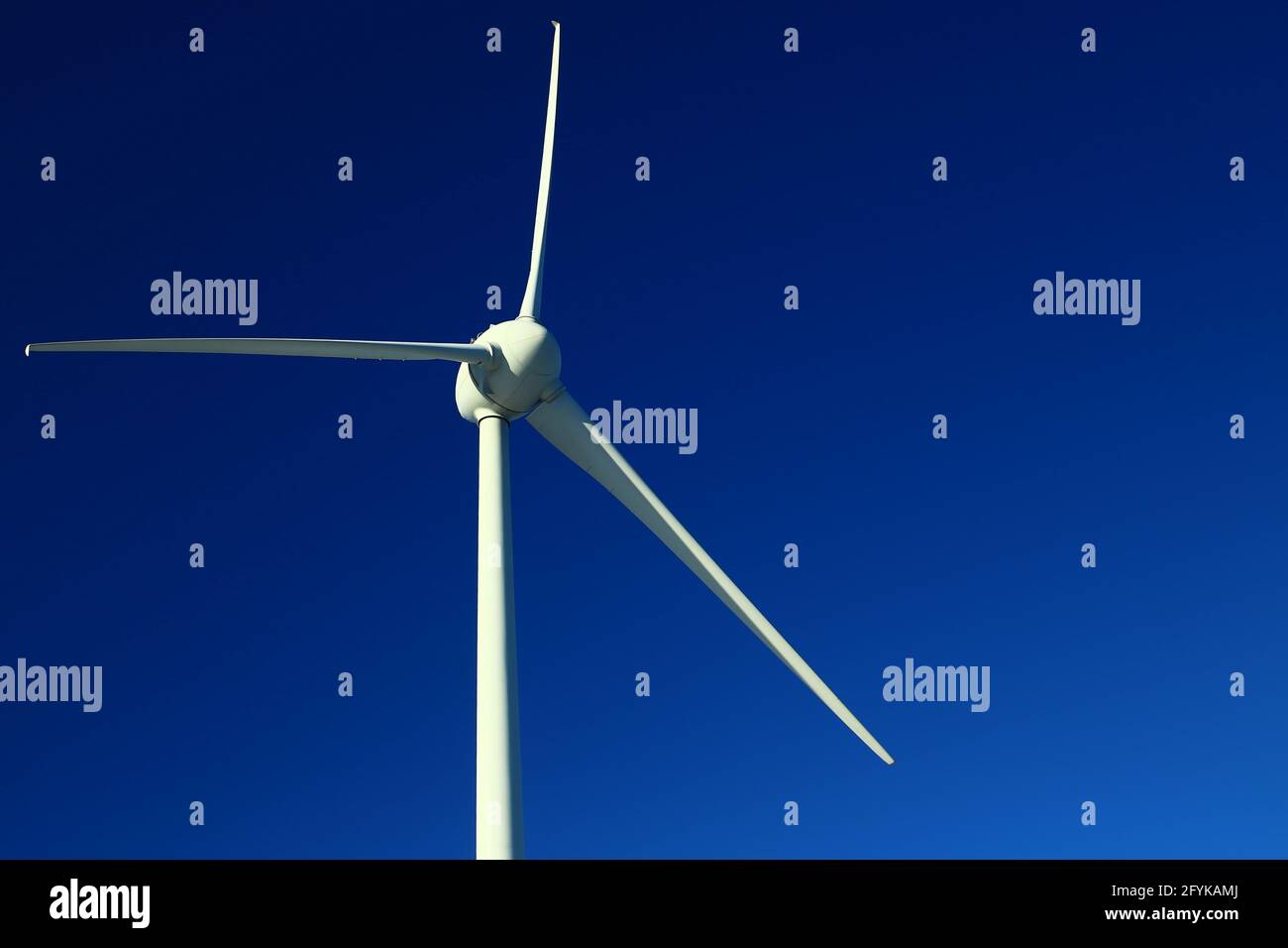 Single wind turbine on dark blue sky Stock Photo - Alamy