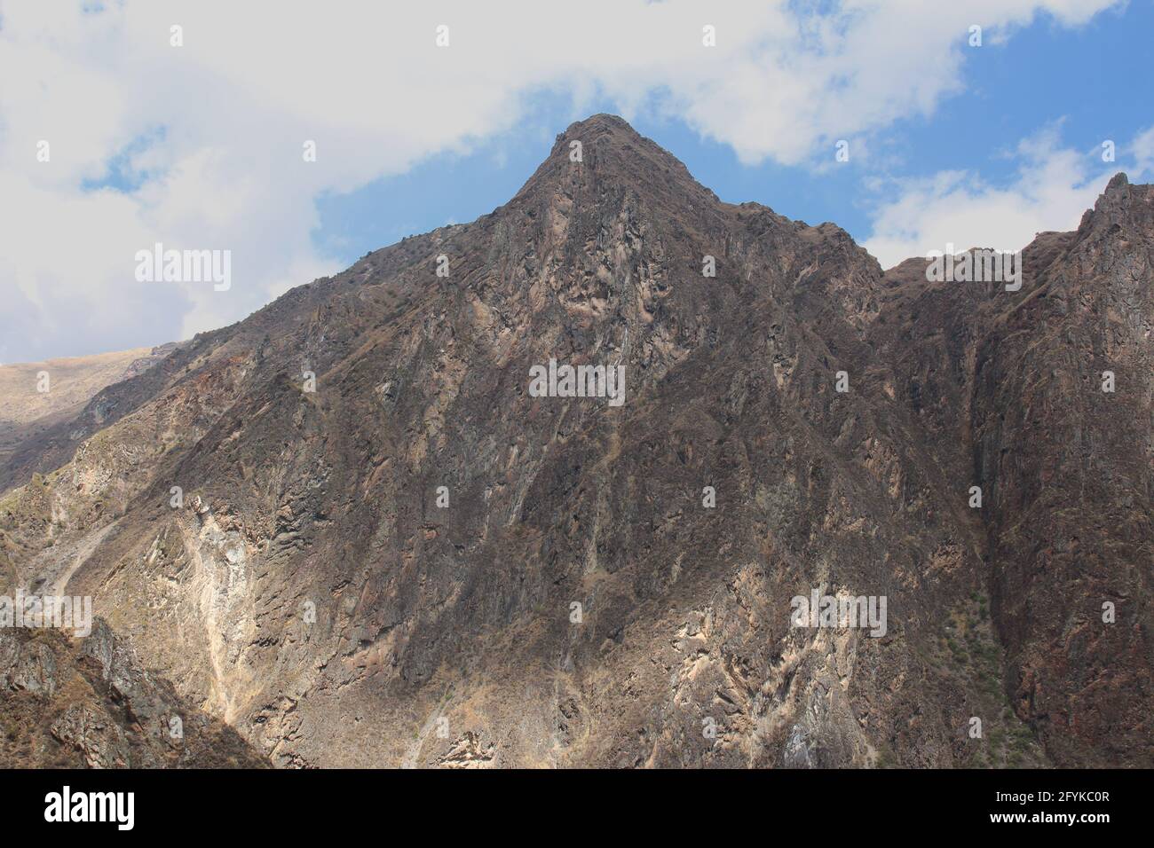 The stark mountainside and summit of the Patacancha Mountains in Urubamba Province in Peru Stock Photo