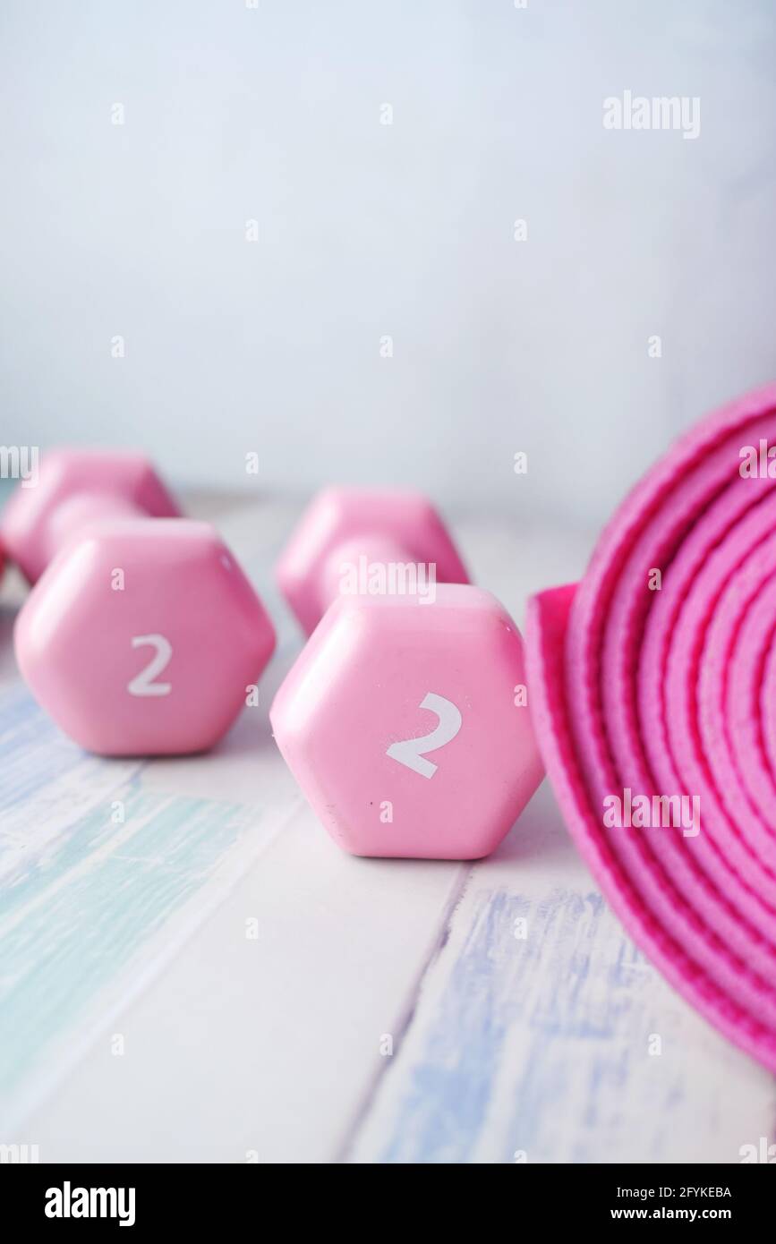 pink color dumbbell, exercise mat and water bottle on white background  Stock Photo - Alamy