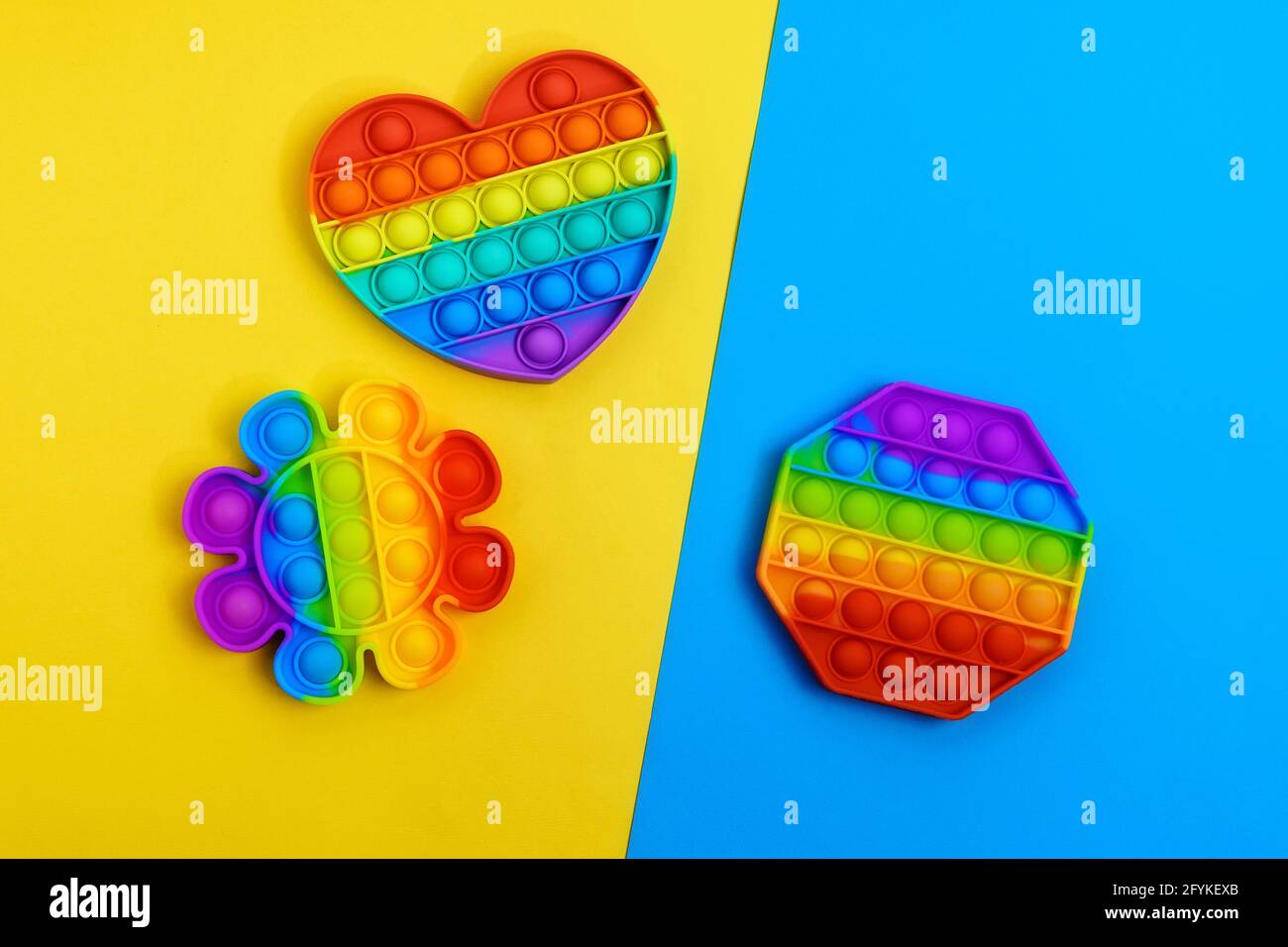 Pop it trendy kids fidget toy isolated on a white background. Rainbow  colored silicone sensory toy. Antistress gadget Stock Photo - Alamy