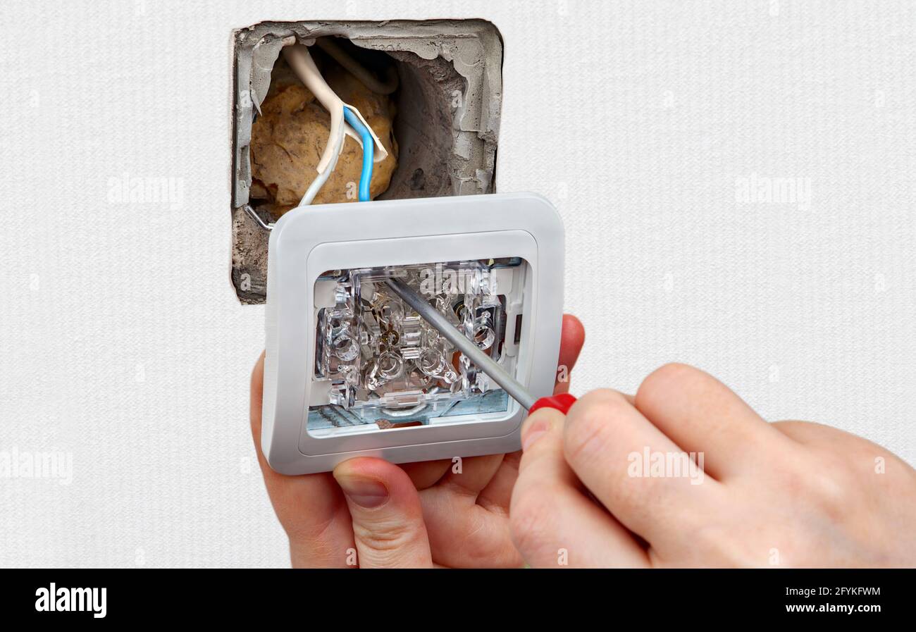 Repair of an electrical outlet or light switch in apartment Stock Photo