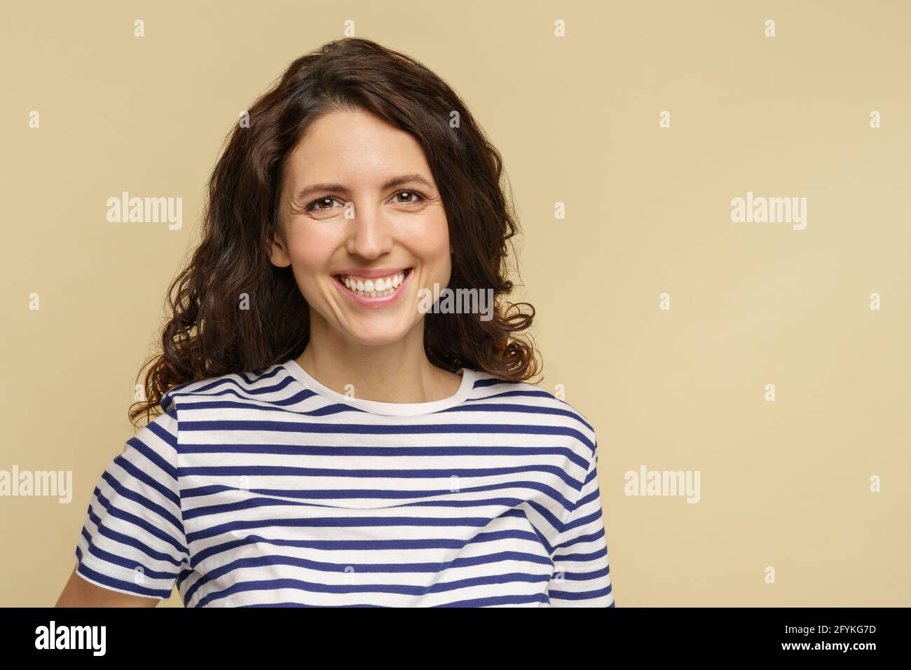 Closeup shot of happy woman with natural makeup healthy skin curly hair, white toothy smile isolated Stock Photo