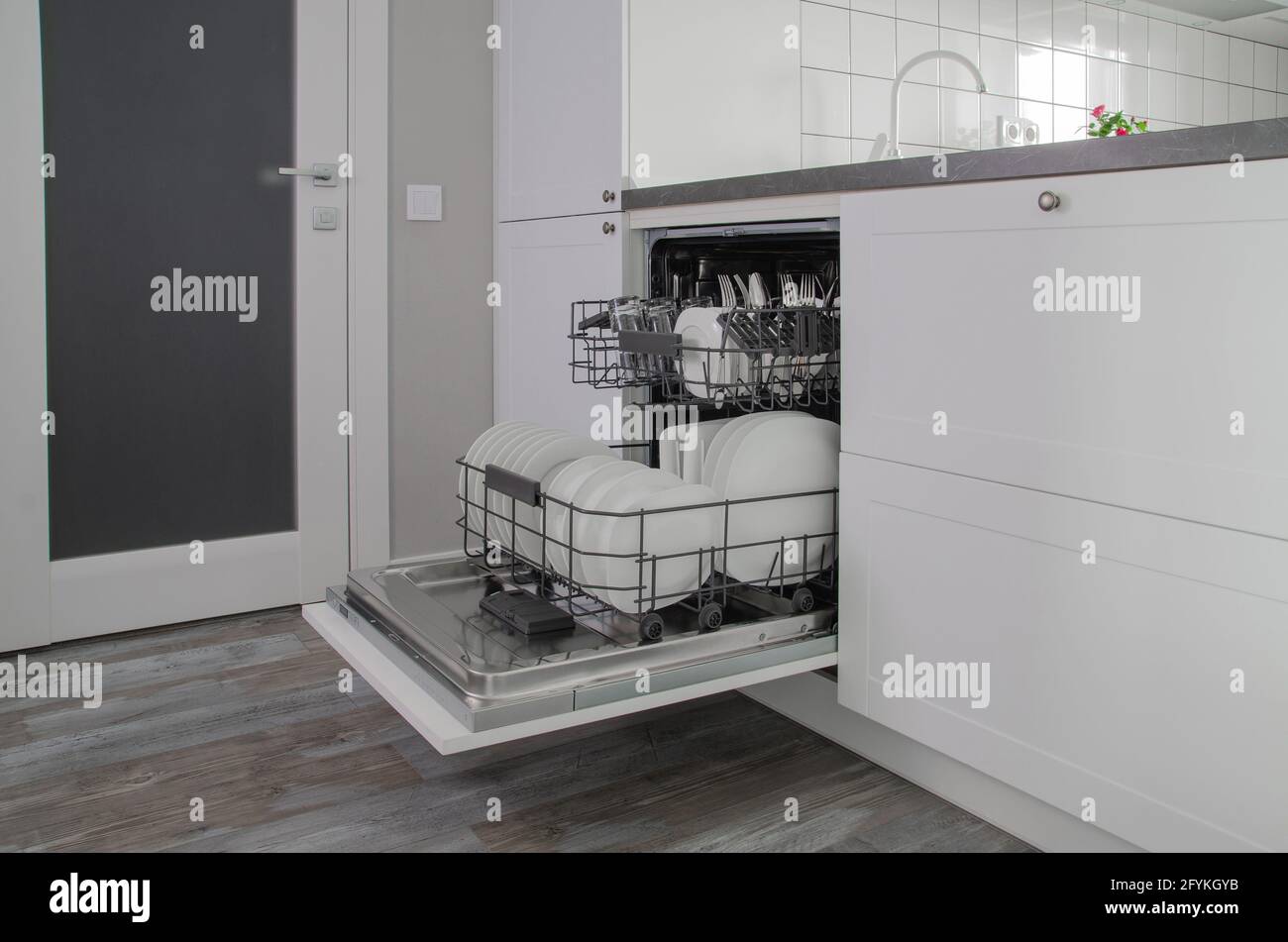 Open dish washing machine. Clean dishes and cups in dishwasher Stock