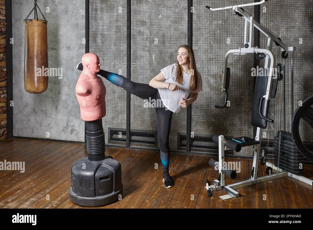 Young fighter boxer girl wearing boxing gloves sitting on the fl Stock Phot...