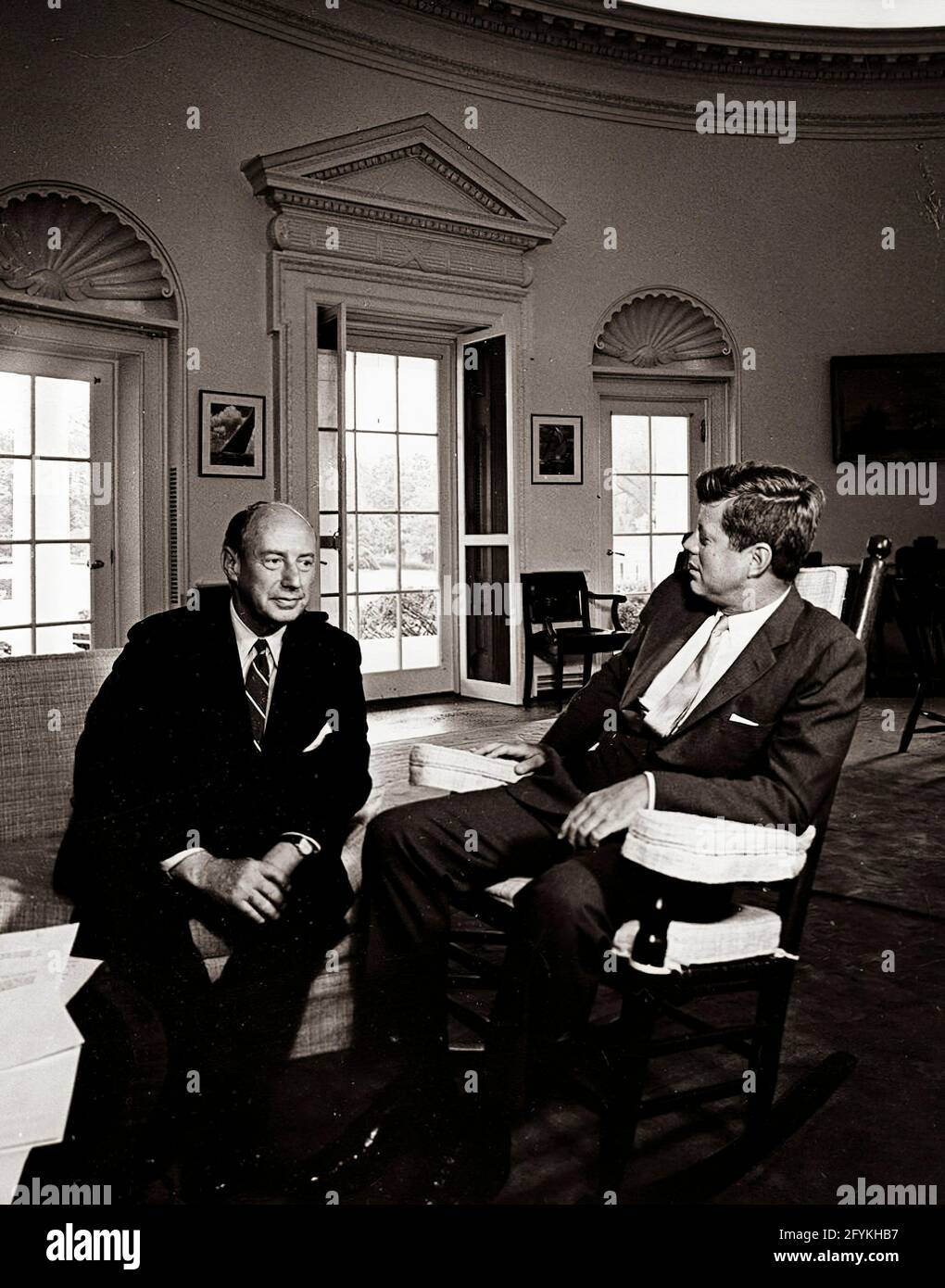 3 August 1961 President John F. Kennedy (in rocking chair) meets with United States Ambassador to the United Nations Adlai E. Stevenson in the Oval Office, White House, Washington, D.C.. Raised in Bloomington, Illinois, Stevenson was a member of the Democratic Party.[1] He served in numerous positions in the federal government during the 1930s and 1940s, including the Agricultural Adjustment Administration, Federal Alcohol Administration, Department of the Navy, and the State Department. In 1945, he served on the committee that created the United Nations. Stock Photo