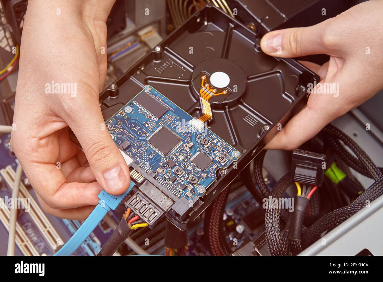 Connecting hard drive to motherboard in computer system unit Stock Photo -  Alamy