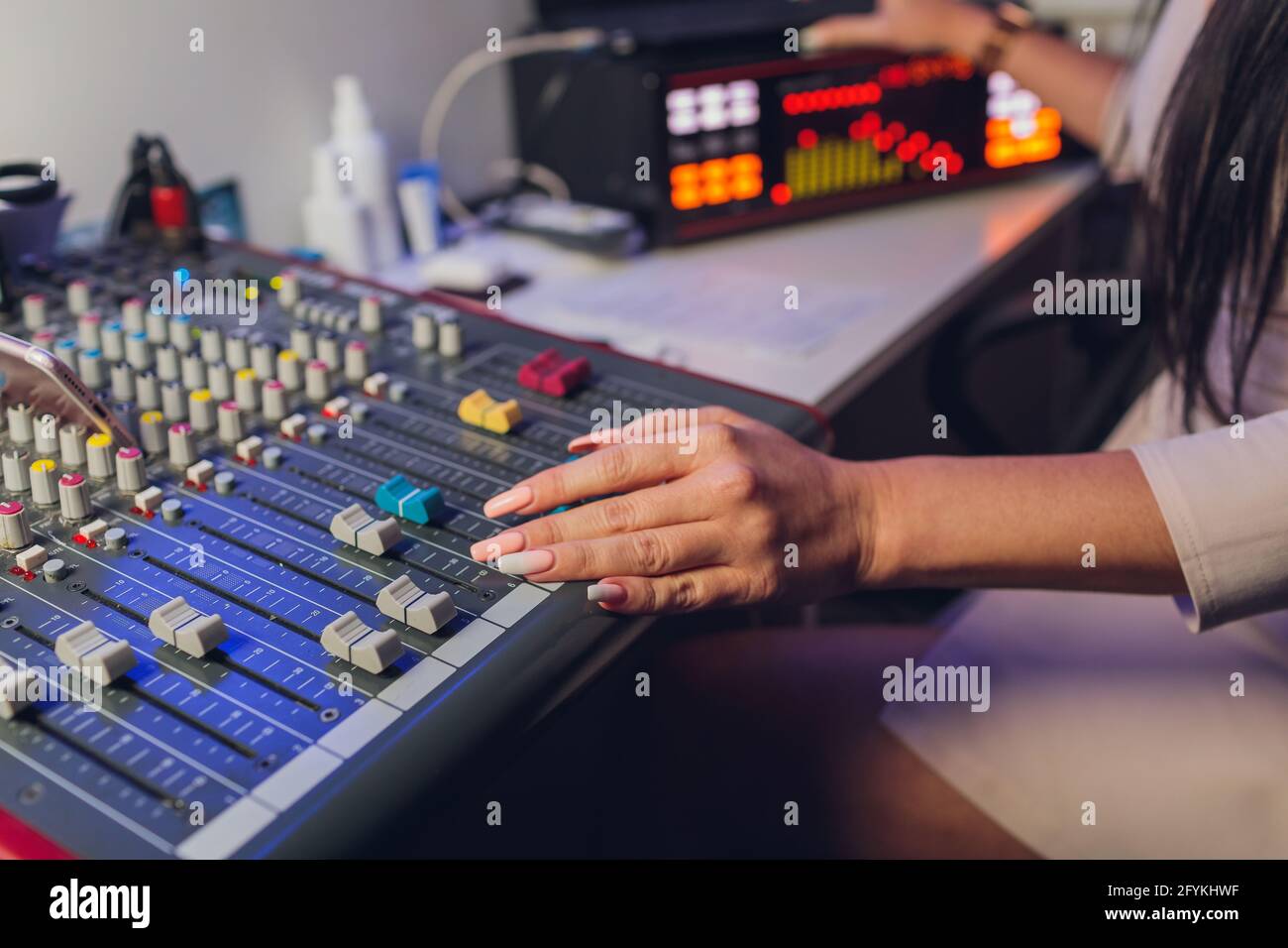 The DJ's hand on the mixer. Dj on the turntables. hand on a mixer close