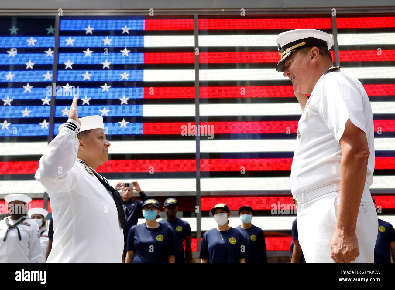 Rear Adm. Charles Rock, Commander, Navy Region Mid-Atlantic gives the oath of enlistment to Aviation Ordnanceman First Class Jessi Arnold, who re-enlisted in the Navy, in Times Square during the annual Fleet Week in New York City, U.S., May 28, 2021.  REUTERS/Brendan McDermid Stock Photo