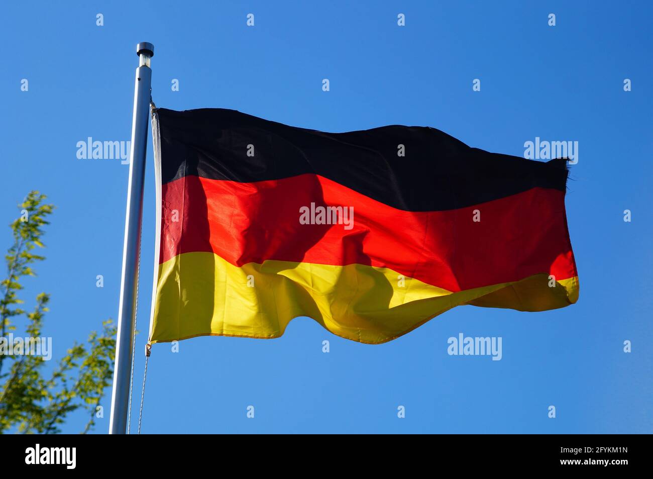 The German flag flies in the evening light. Stock Photo