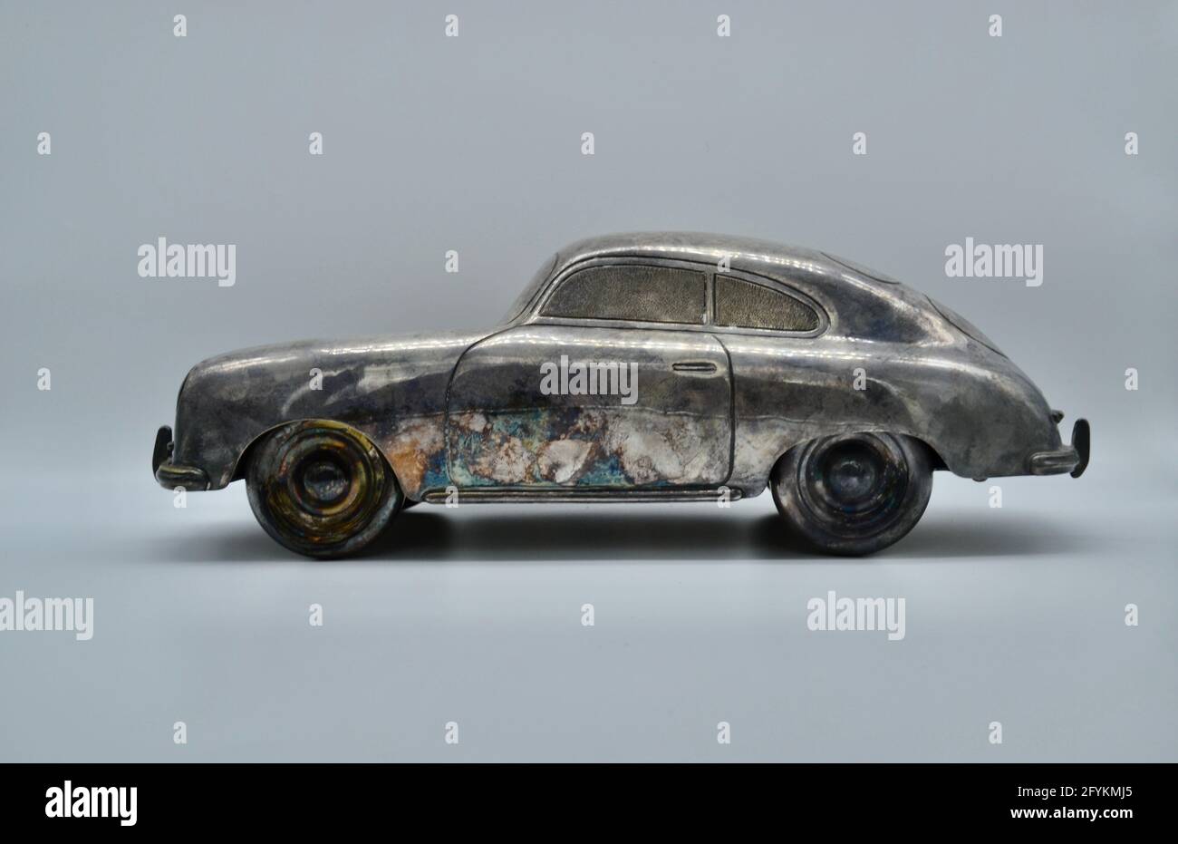 Side view of vintage toy metal Porsche 356 sports car in studio shot on white background Stock Photo