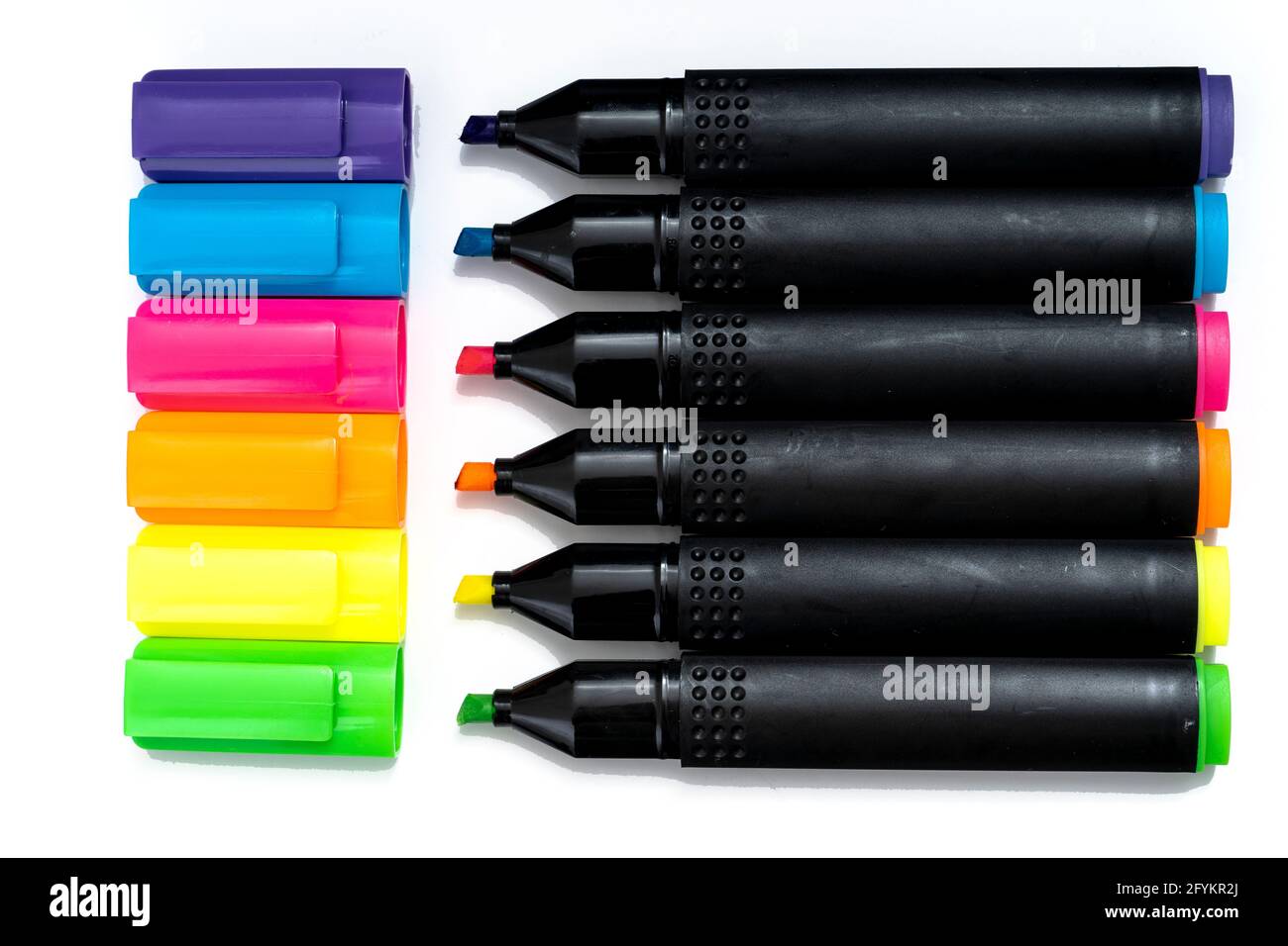 Set of highlighter markers sorted aligned and uncovered on white