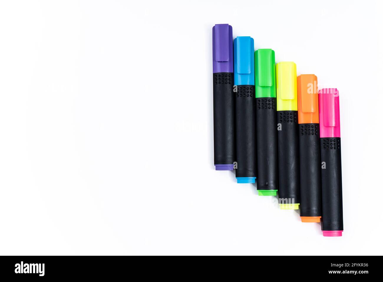 Set of highlighter markers sorted by color aligned in ladder on white background. Stock Photo