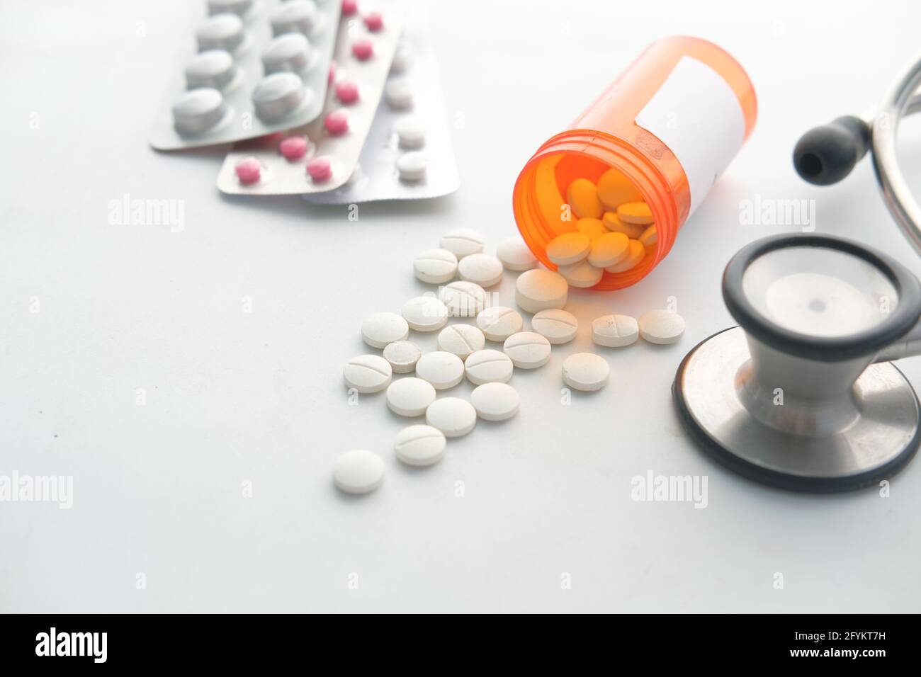 white color medical pills spilling on white Stock Photo - Alamy