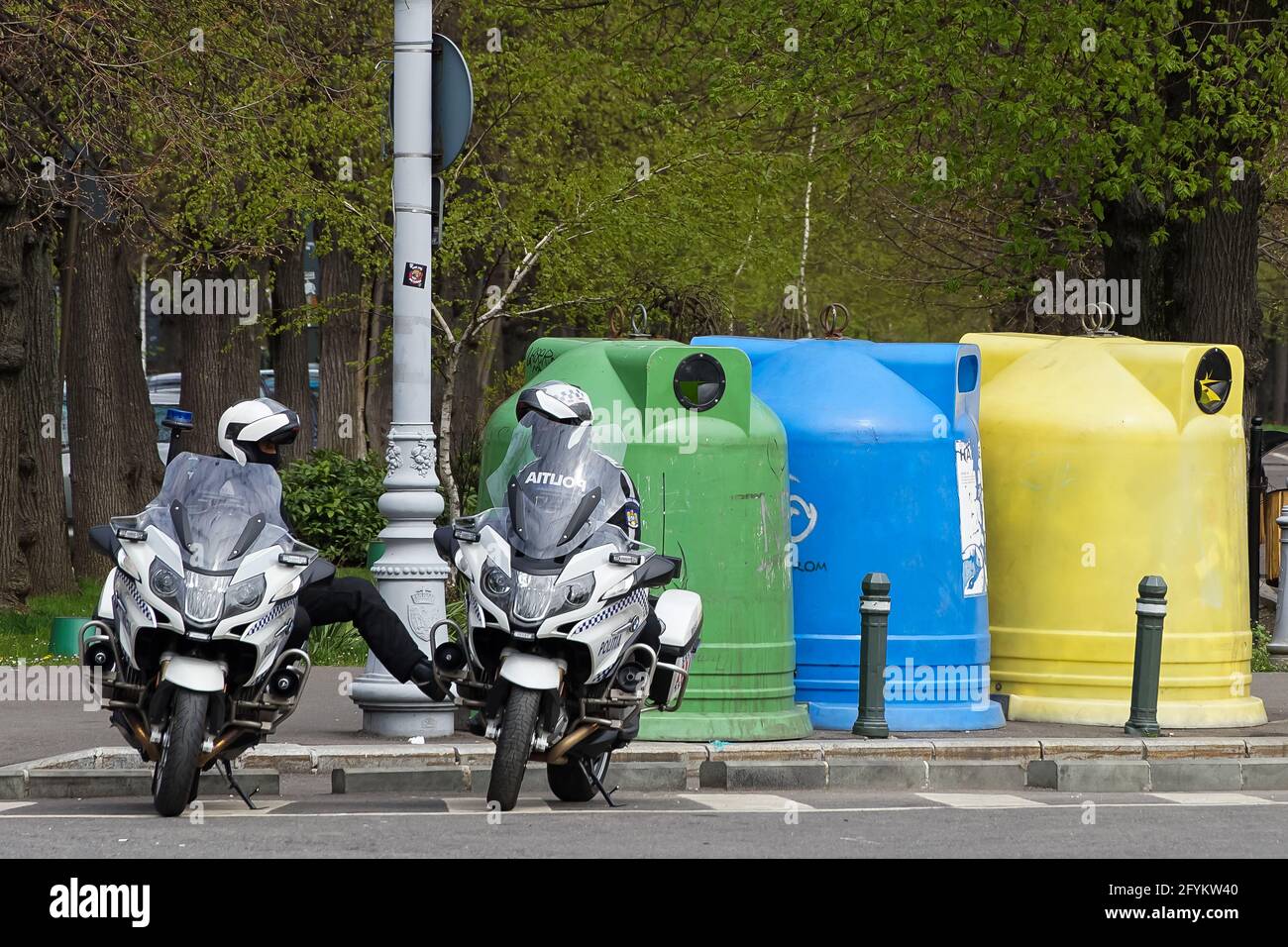 Bucharest, Romania - April 15, 2021: Two policemen sitting on BMW R 1200 RT authority motorcycles, talking to each other, in Bucharest. This image is Stock Photo