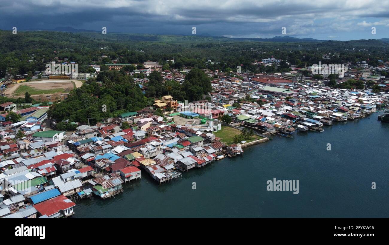 Isabela City, Philippines. 28th May, 2021. Drone image of Isabela City which was placed under General Community Quarantine (GCQ) status from May 28 to June 10, 2021 following the surge of COVID-19 cases in the city. (Photo by Sherbien Dacalanio/Pacific Press) Credit: Pacific Press Media Production Corp./Alamy Live News Stock Photo