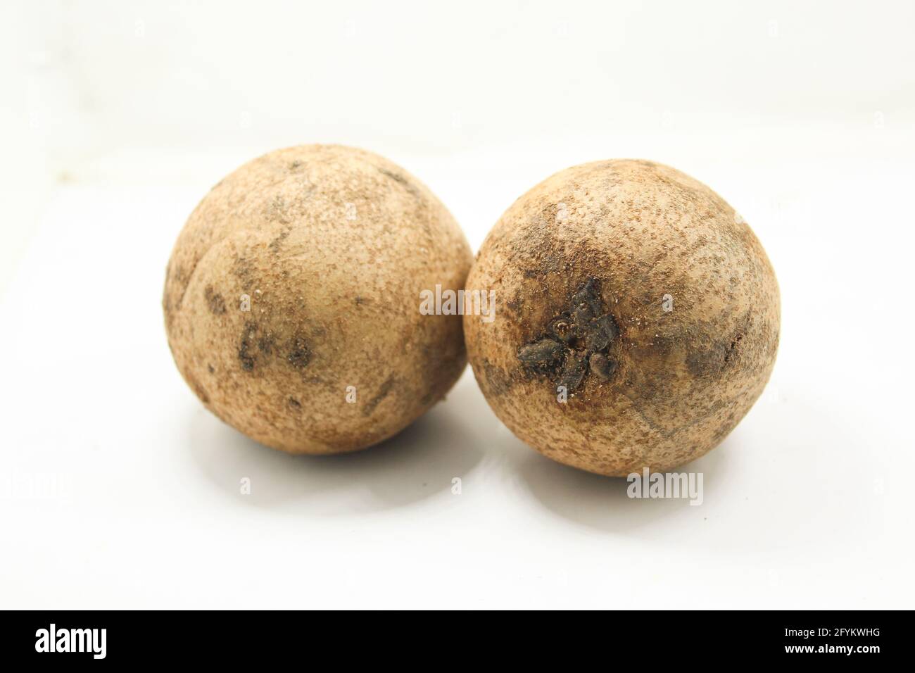 Sapodilla fruit on isolated white surface Stock Photo