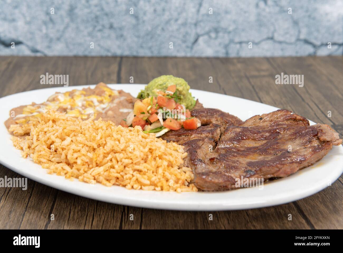 Carne Asada steak cooked to perfection and served with rice and beans