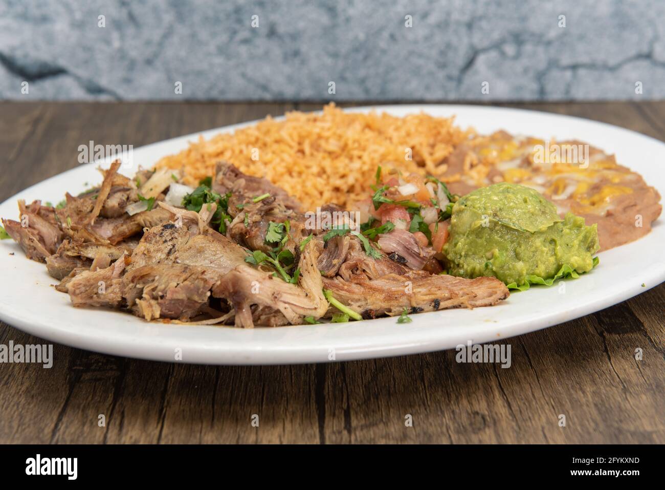 Shredded carnitas pork cooked to perfection and served with rice and