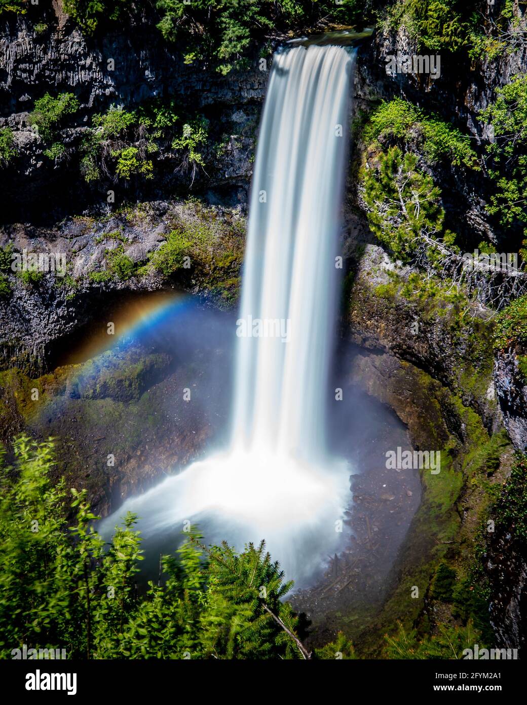 Rainbow at the base of a smooth looking Brandywine Falls at the Sea to Sky Highway between