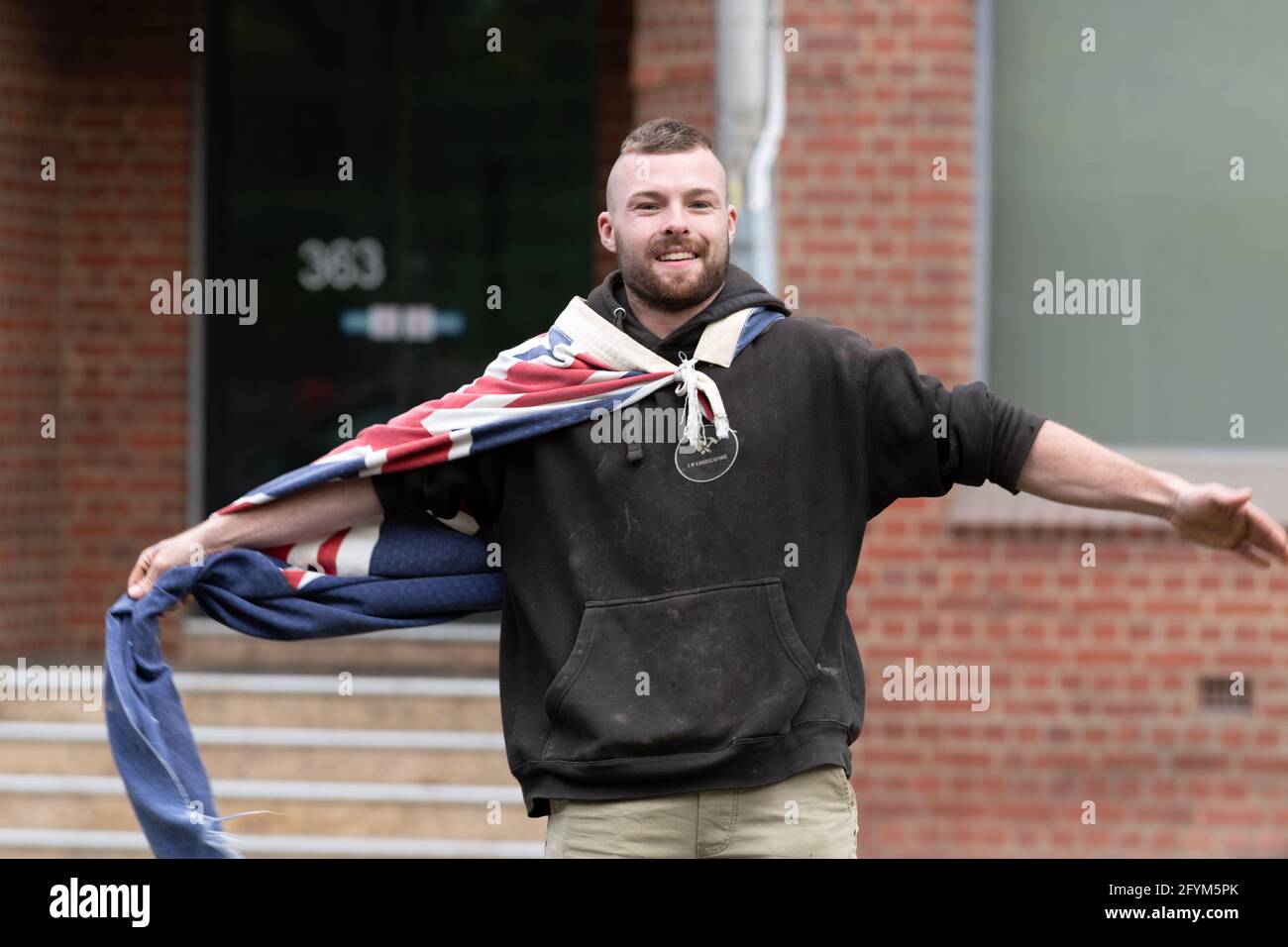 Melbourne, Australia 29 May 2021, A protester wearing an Australian flag during a planned 'Millions March' rally at Flagstaff Gardens, that had been canceled by organisers due to the snap lockdown. Hardcore anti-lockdown and anti-vaccination protesters still attend the park and rallied against the government. Credit: Michael Currie/Alamy Live News Stock Photo