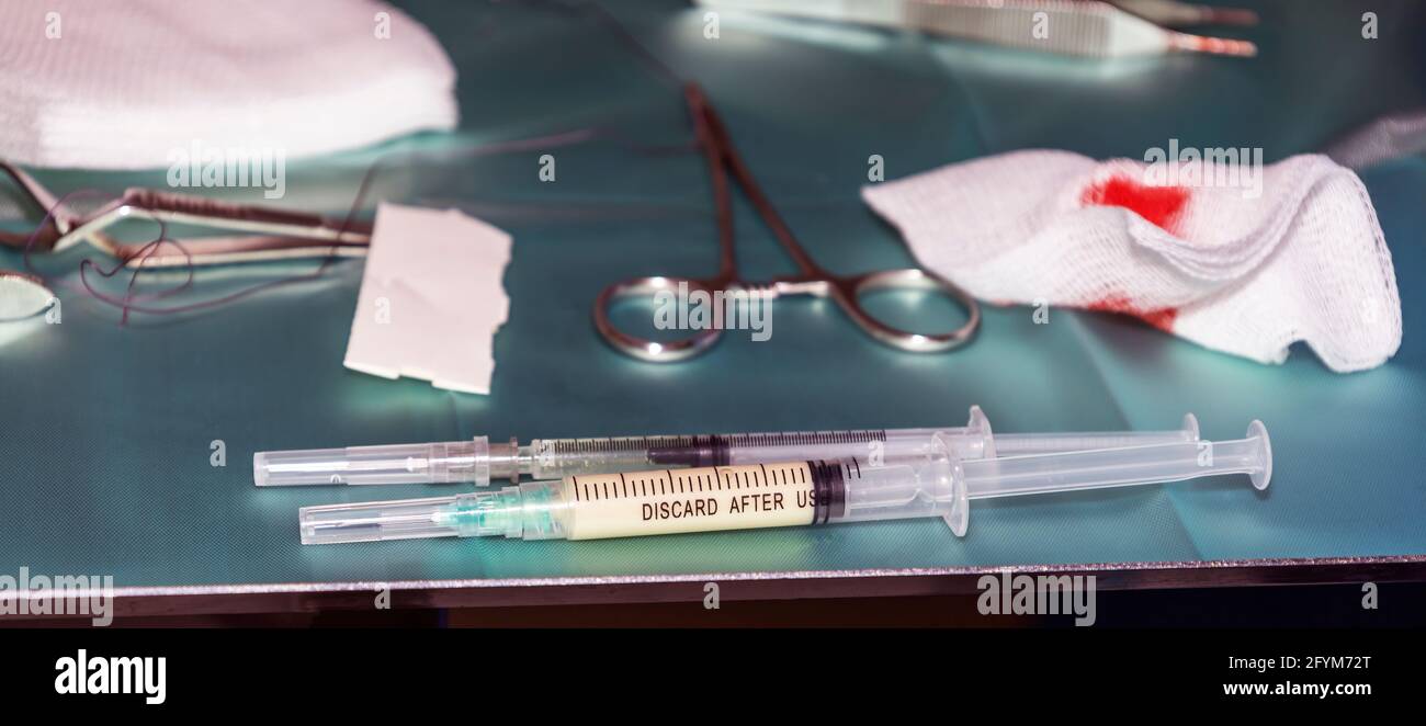 Two syringes lying on a medical tray with anesthesia during a complex surgical procedure Stock Photo