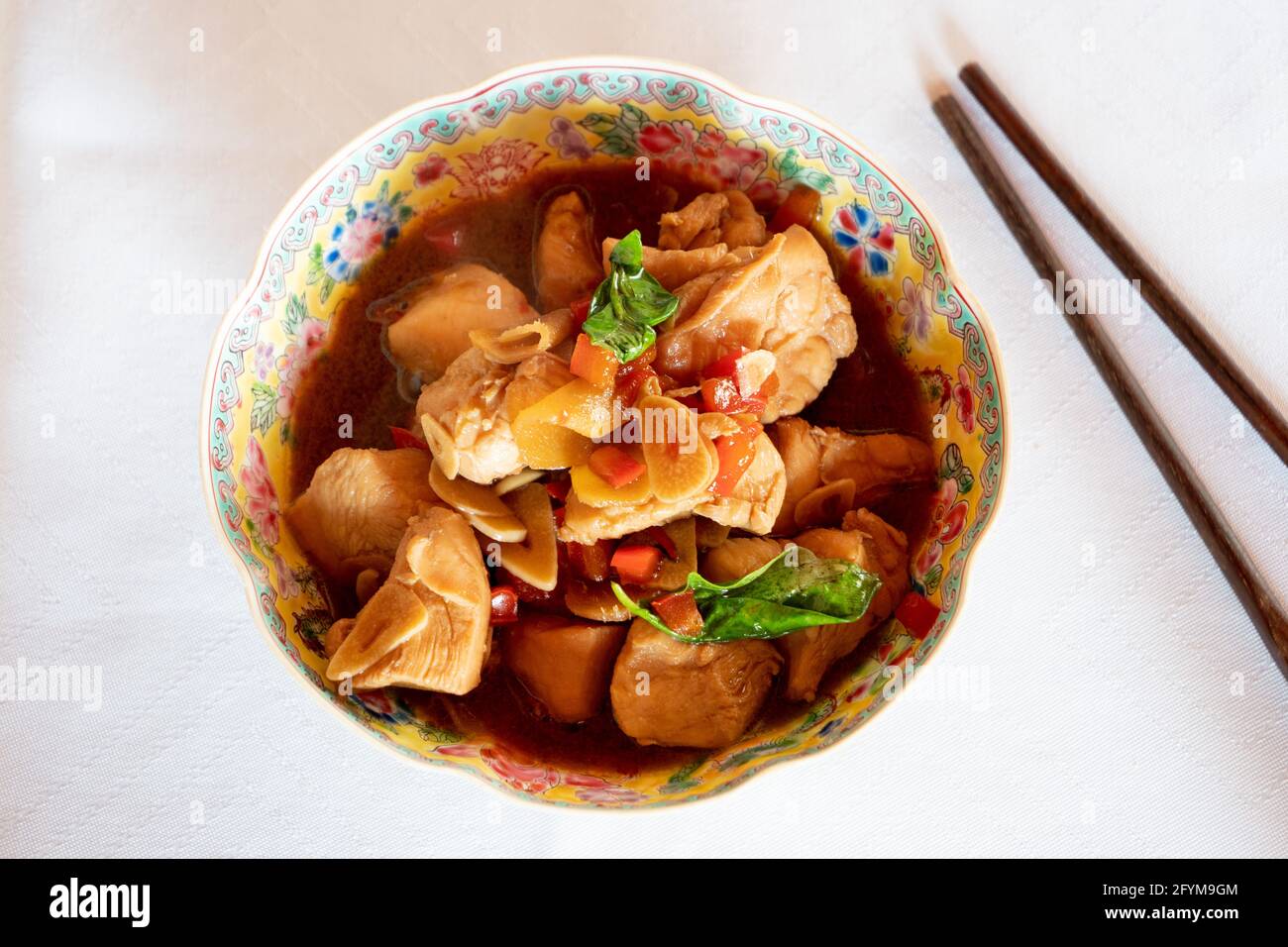 San Bei Ji Three Cup Chicken in a Traditional Chinese Bowl with Chopsticks, a Traditional Dish of the Taiwanese Cuisine Stock Photo