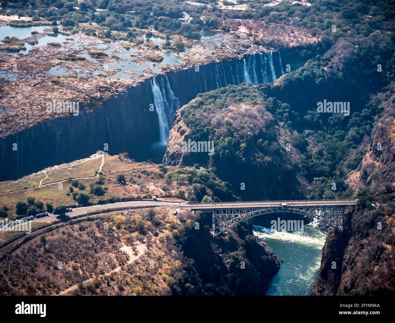 Victoria Falls Waterfall with Bridge over the Zambezi River connecting Zimbabwe and Zambia, Africa Stock Photo