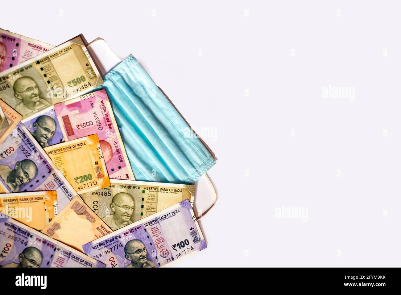 Indian rupee and protective face masks isolated on white background ...