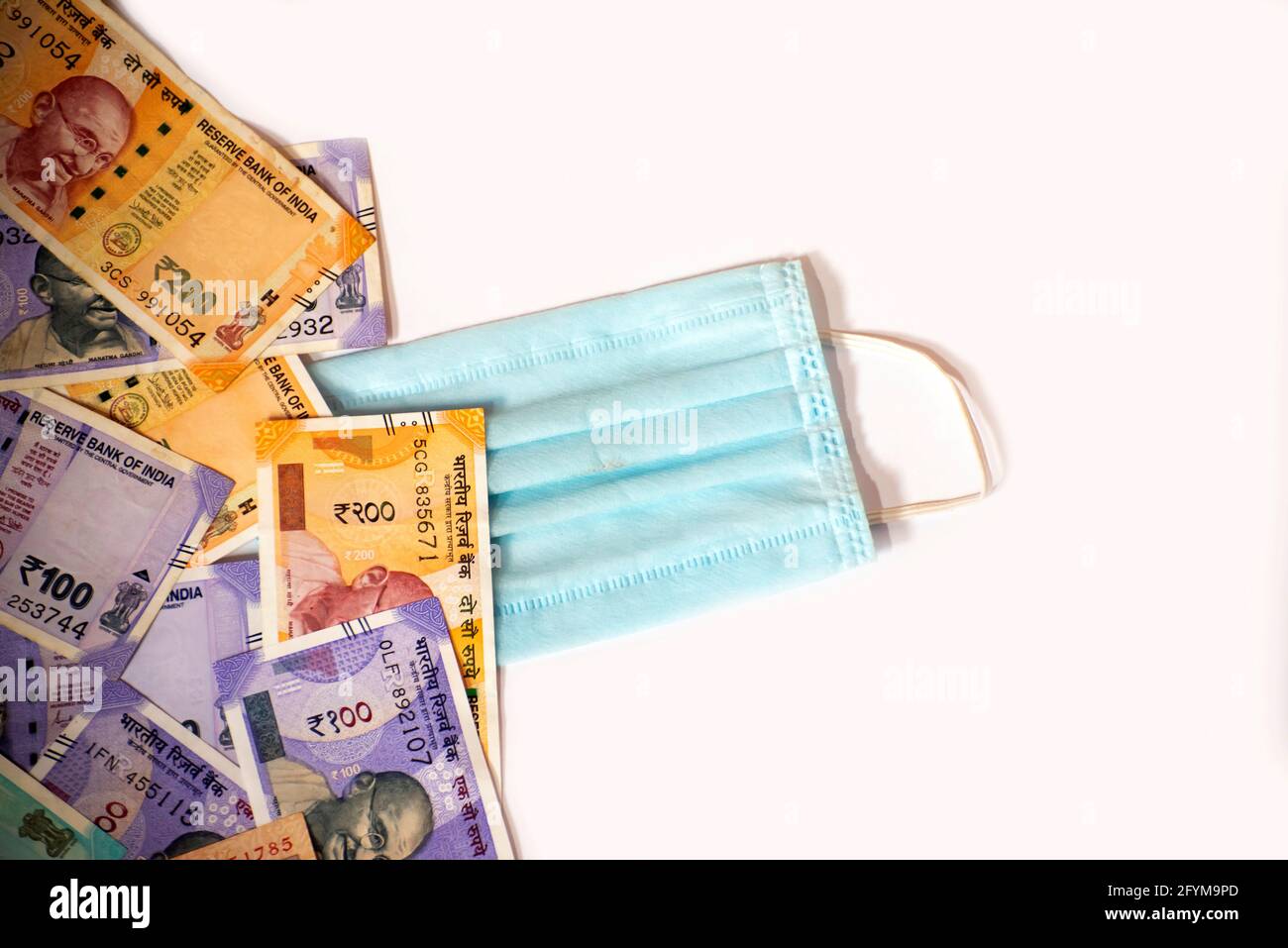Indian rupee and protective face masks isolated on white background ...