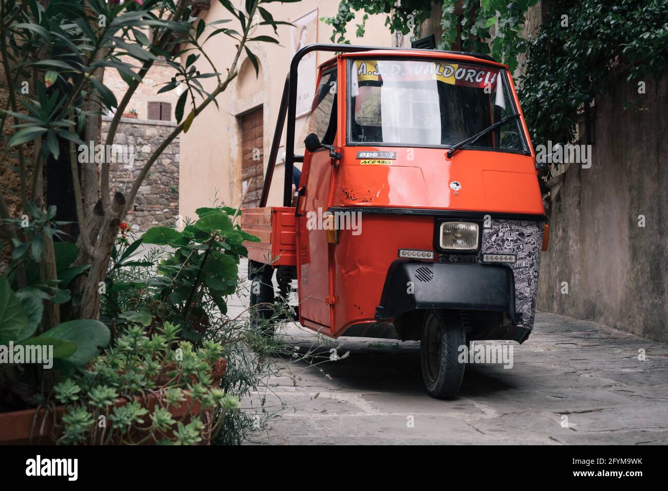Castiglione d'Orcia, Italy - August 18 2020: Piaggio Ape 50, an Italian three-wheeled light commercial vehicle based on the Vespa Scooter. Stock Photo