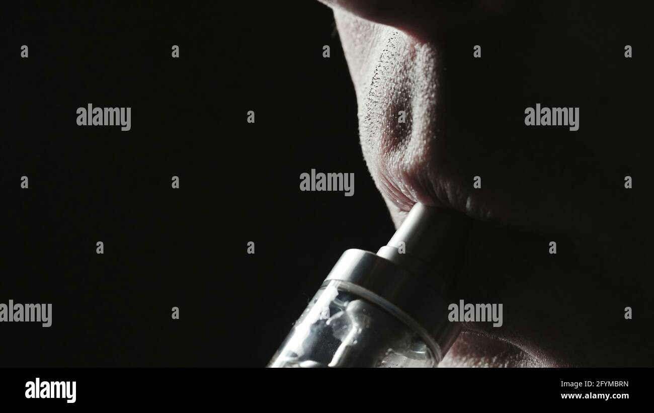 Closeup photo of smoker man on black Stock Photo