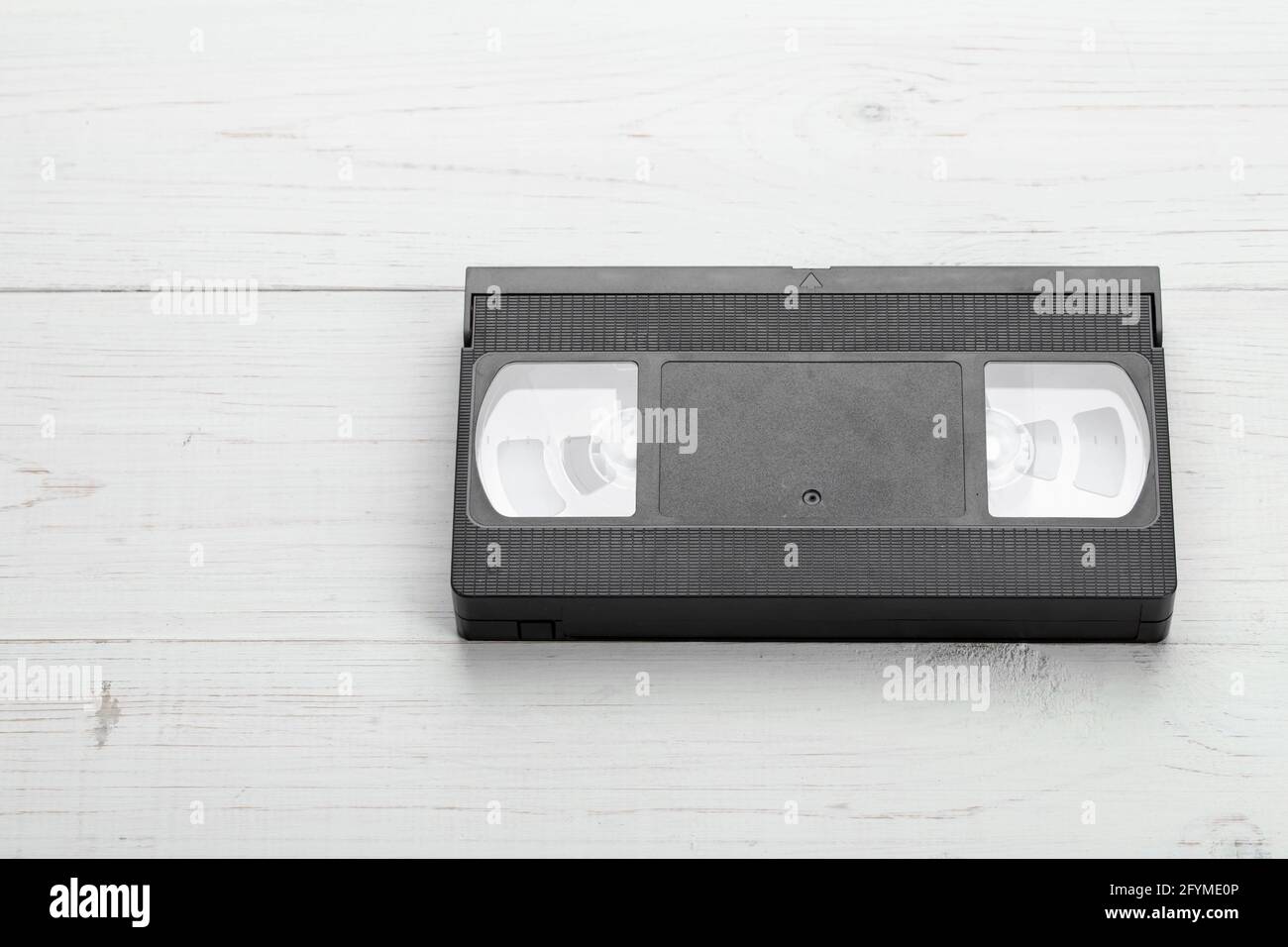 VHS tape from the 80s and 90s on white wood background. Retro media