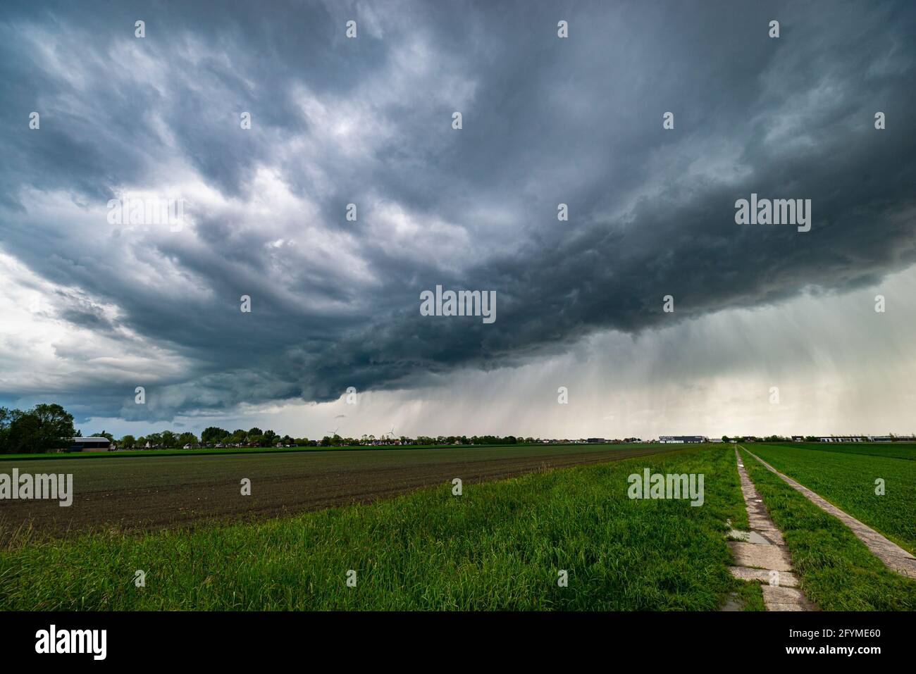 Thunderstorm with developing arcus or shelf cloud over the Dutch countryside Stock Photo