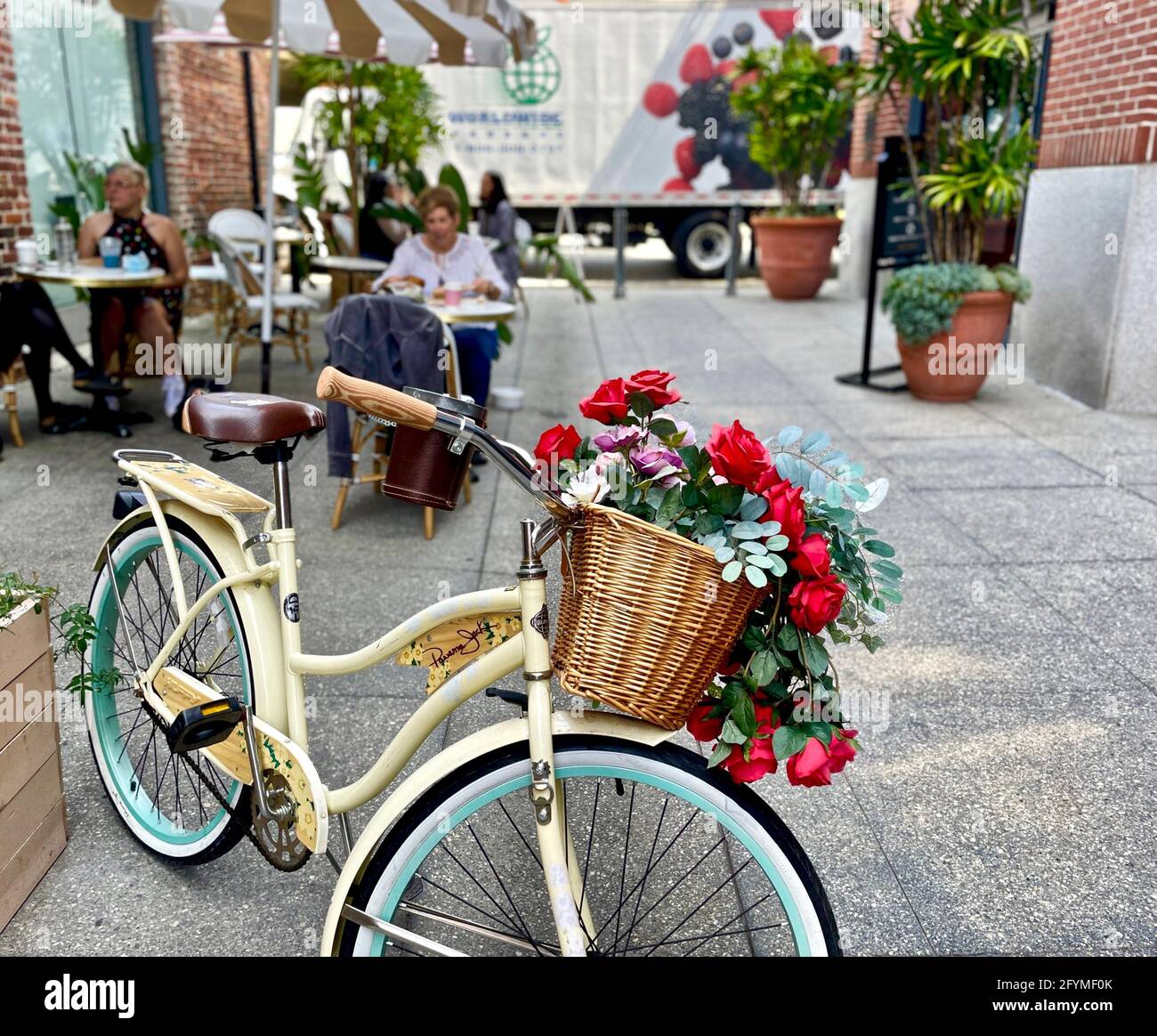 Pasadena, California, USA. 28th May, 2021. Flowers in a basket on a bike at  'Coffee and Plants' bakery and cafe, outside seating area. a Vegan Bakery  and cafe at 62 W Union