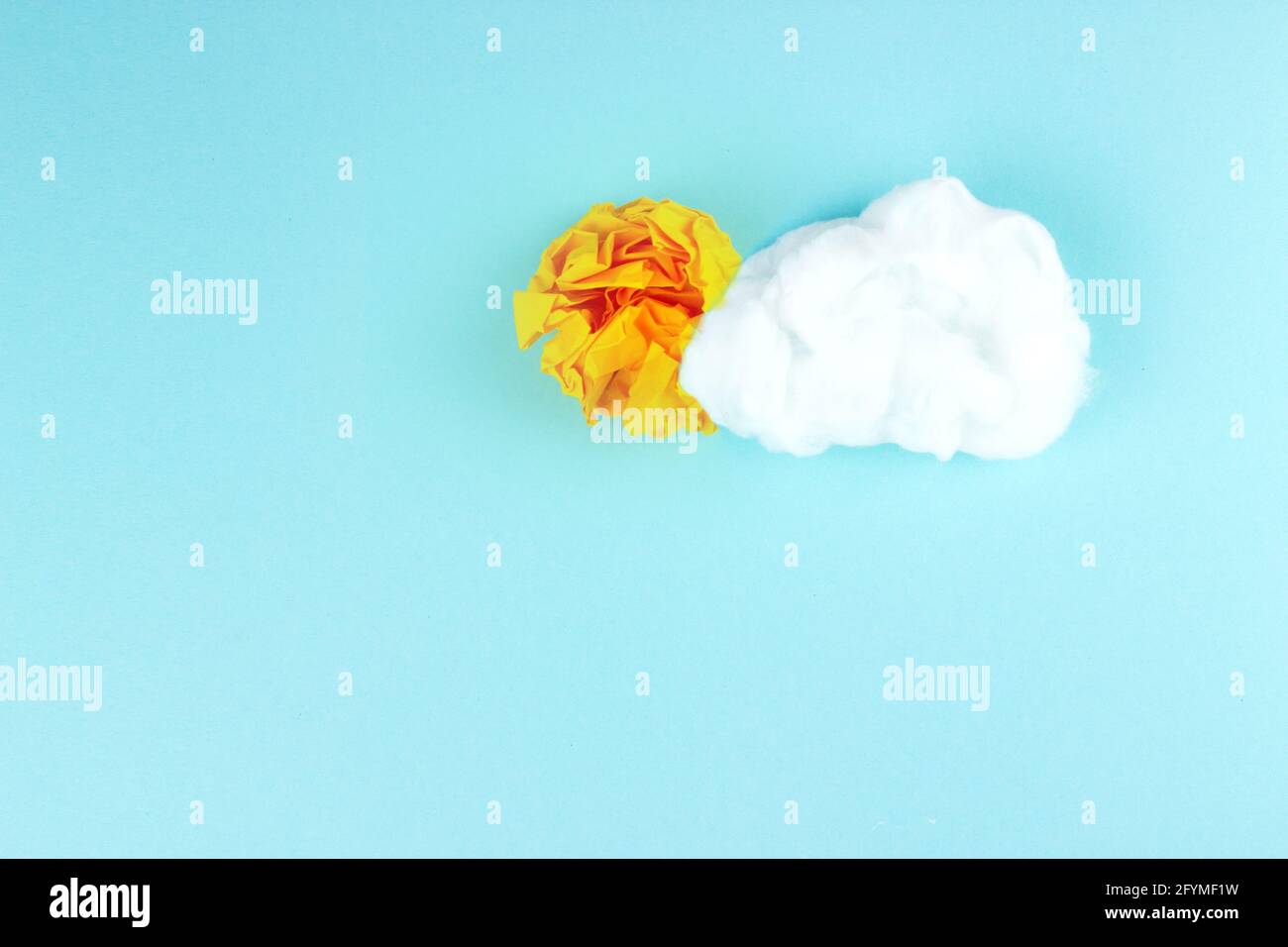 Shining sun concept with crumpled paper ball and cloud. Idea Concept Background. Stock Photo