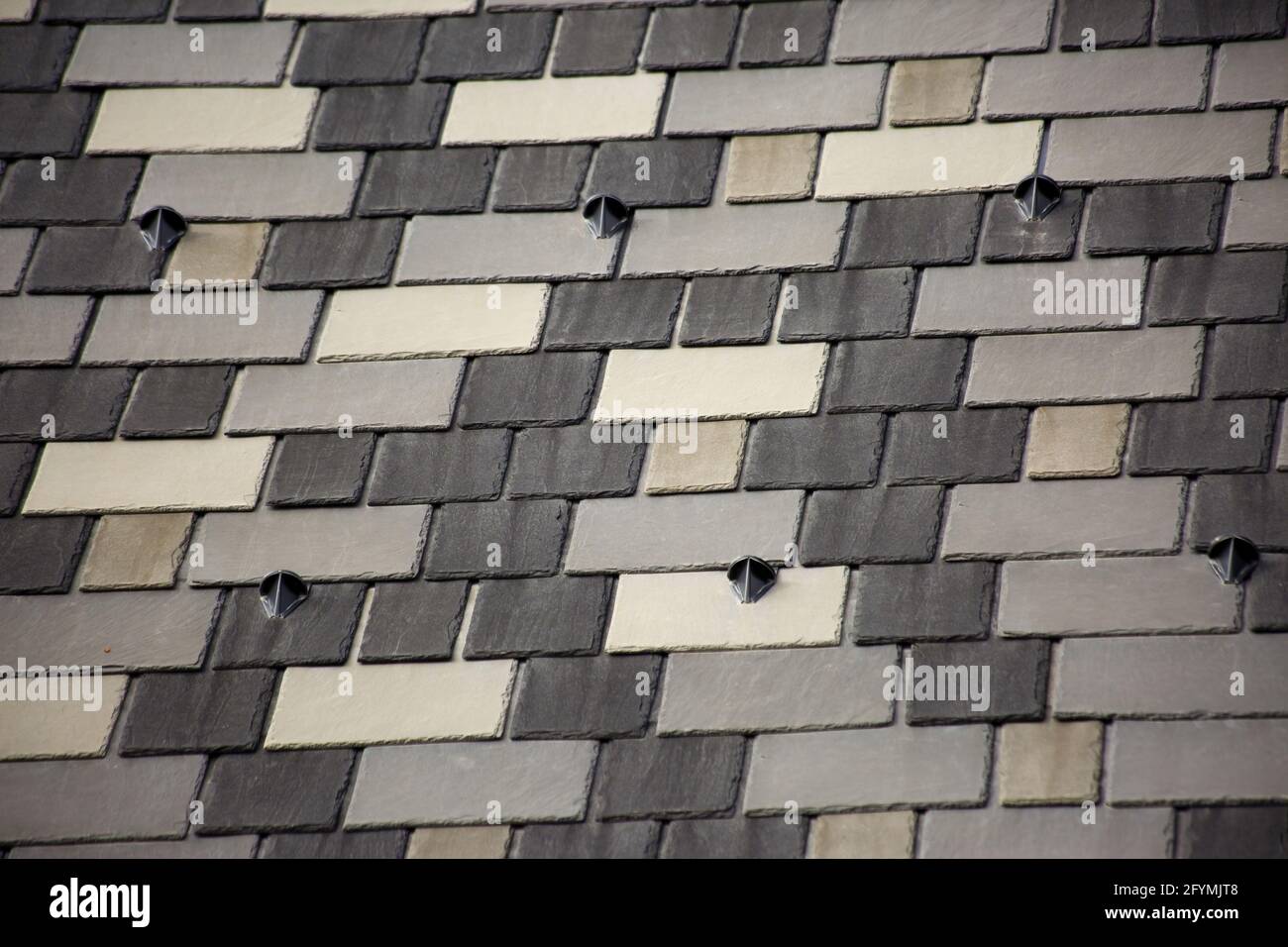 Closeup shot of snow brackets on the shingles roof Stock Photo