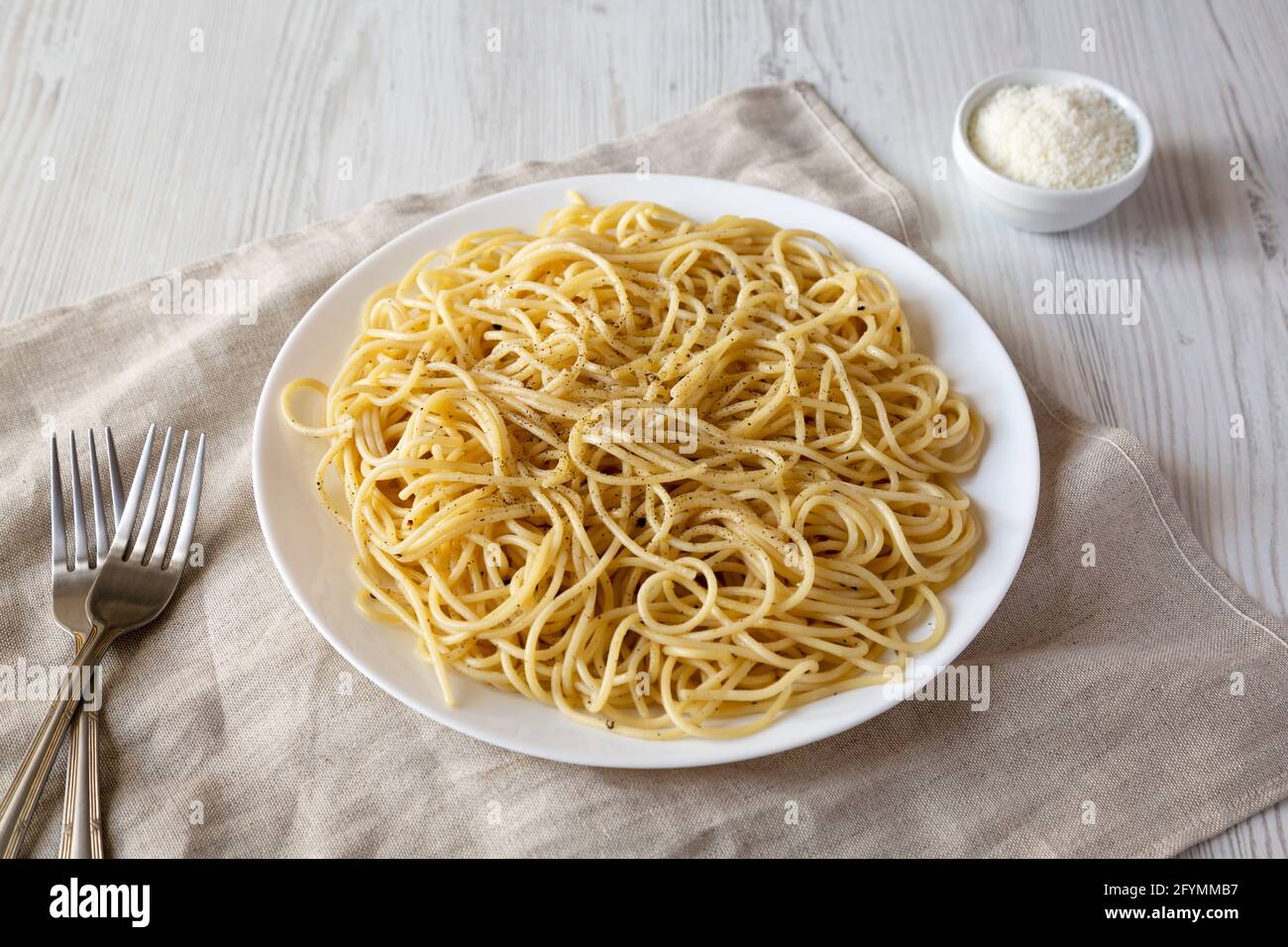 Homemade Cacio E Pepe Pasta with Pecorino Romano and Pepper on a white