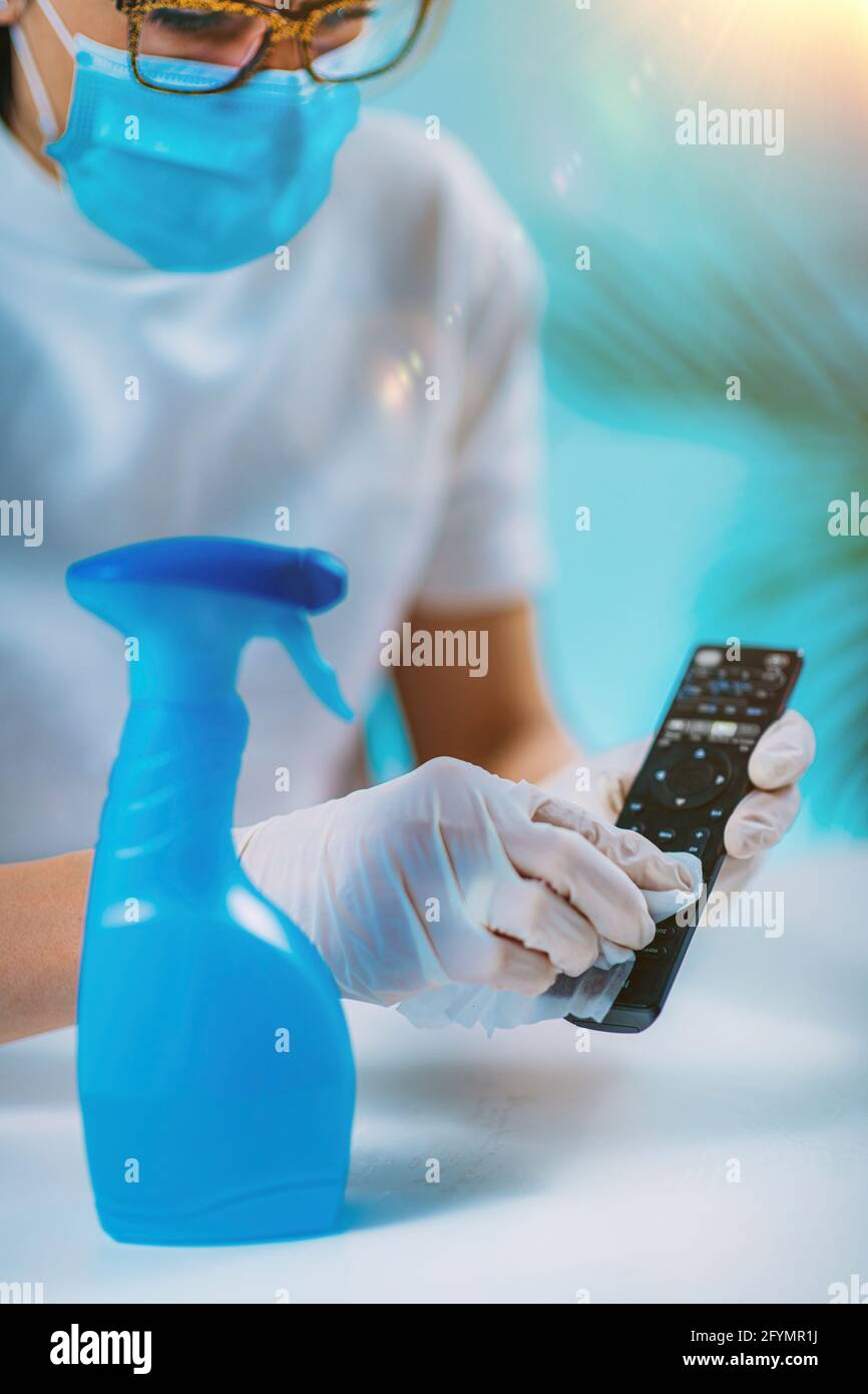 Disinfecting remote controller with alcohol disinfectant Stock Photo
