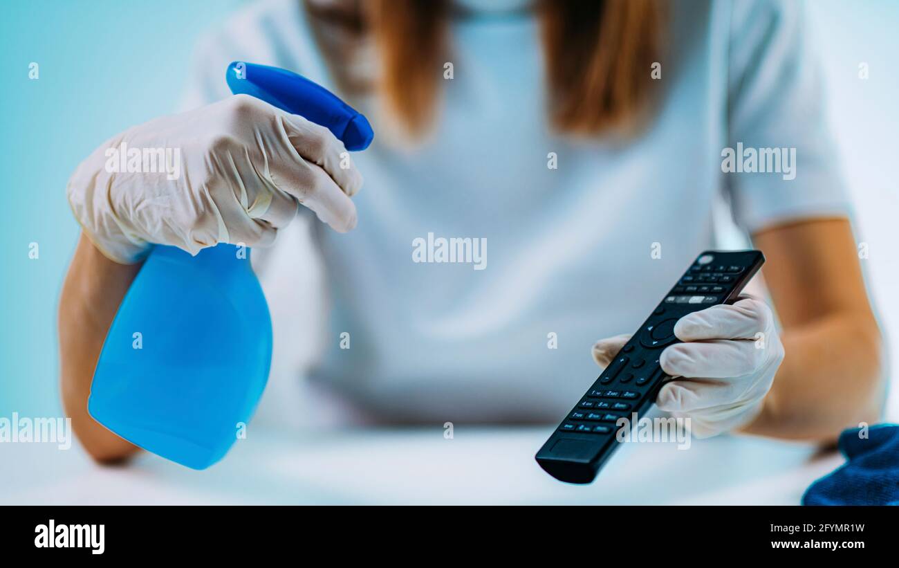 Disinfecting remote controller with alcohol disinfectant Stock Photo