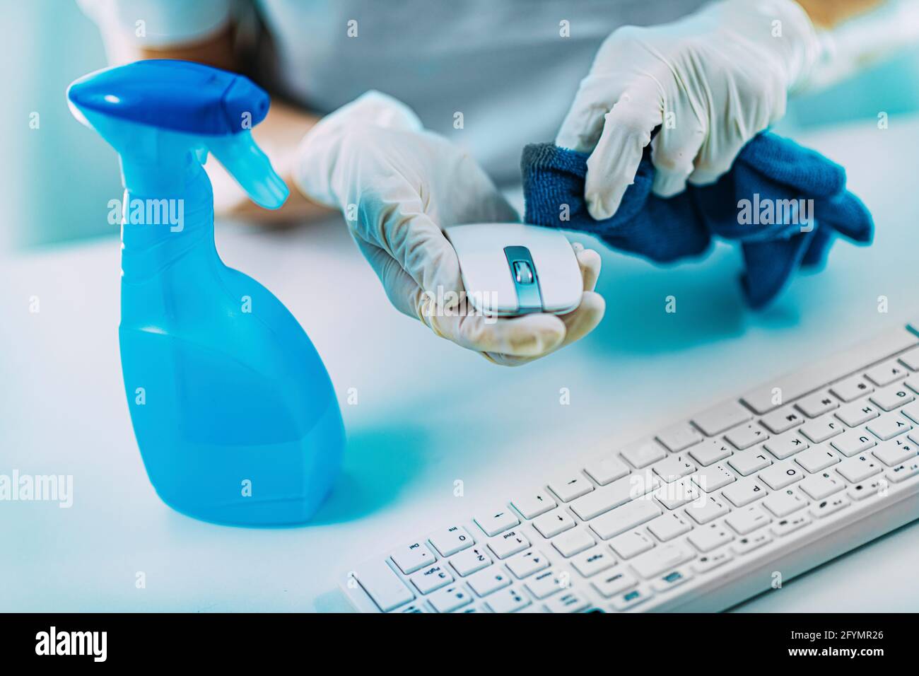 Disinfection of computer keyboard and mouse with alcohol Stock Photo