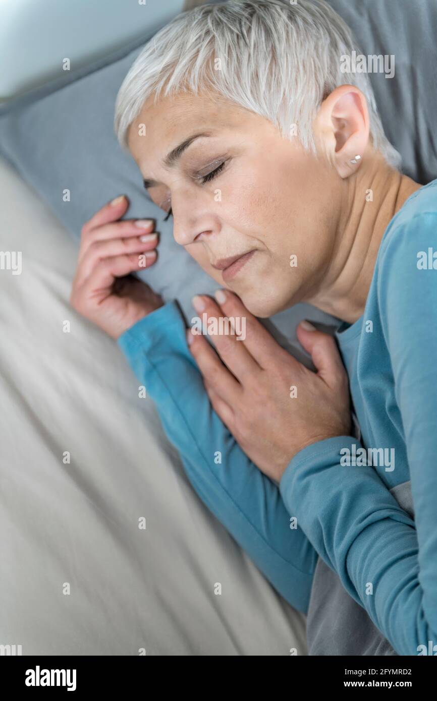 Mature woman lying asleep hi-res stock photography and images - Alamy