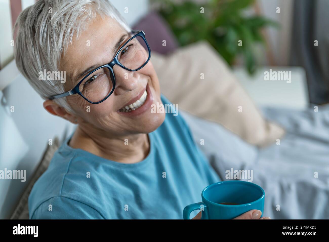 Smiling woman drinking coffee Stock Photo