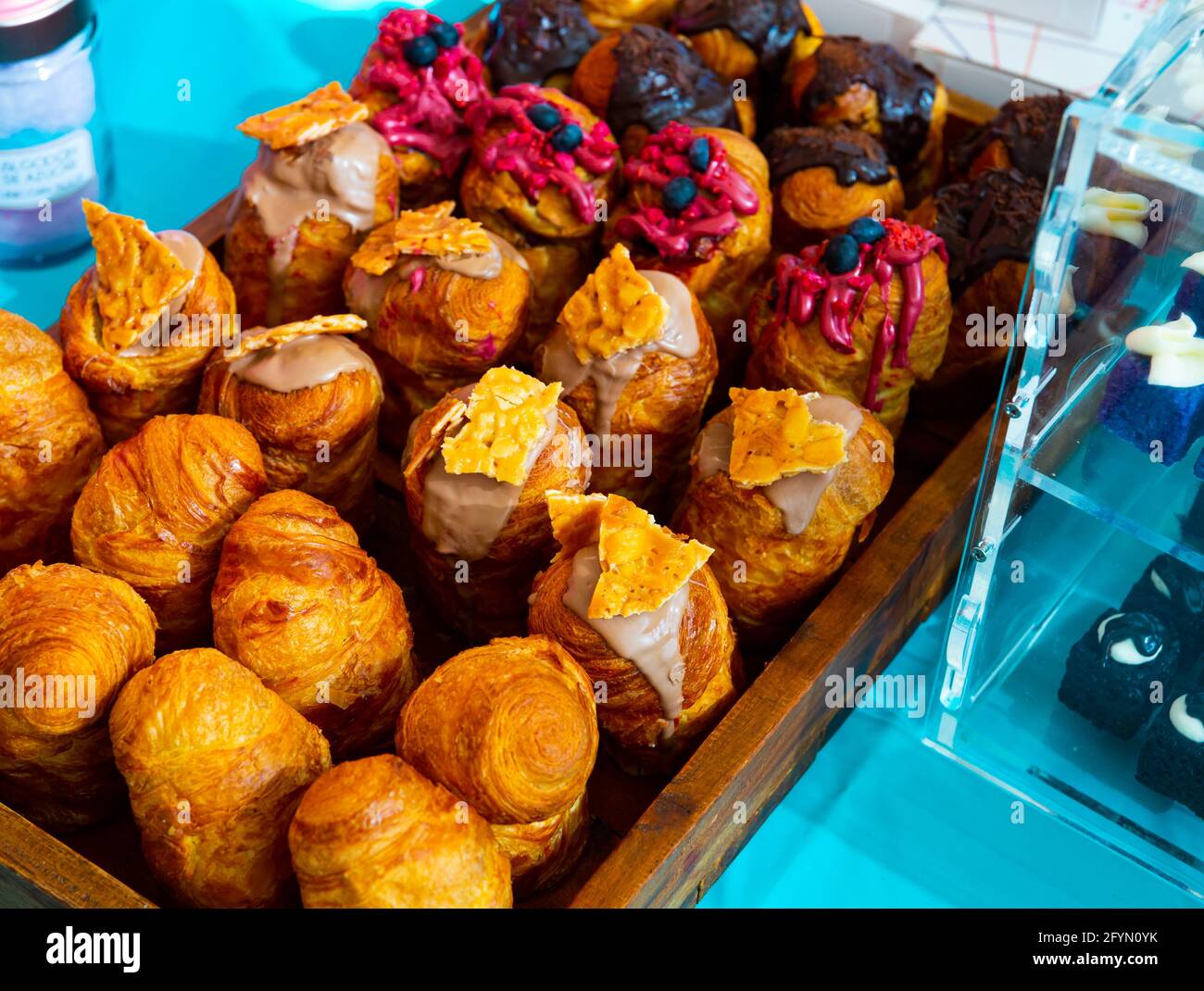 Assorted freshly baked sweet yeast dough cruffins with various topping Stock Photo