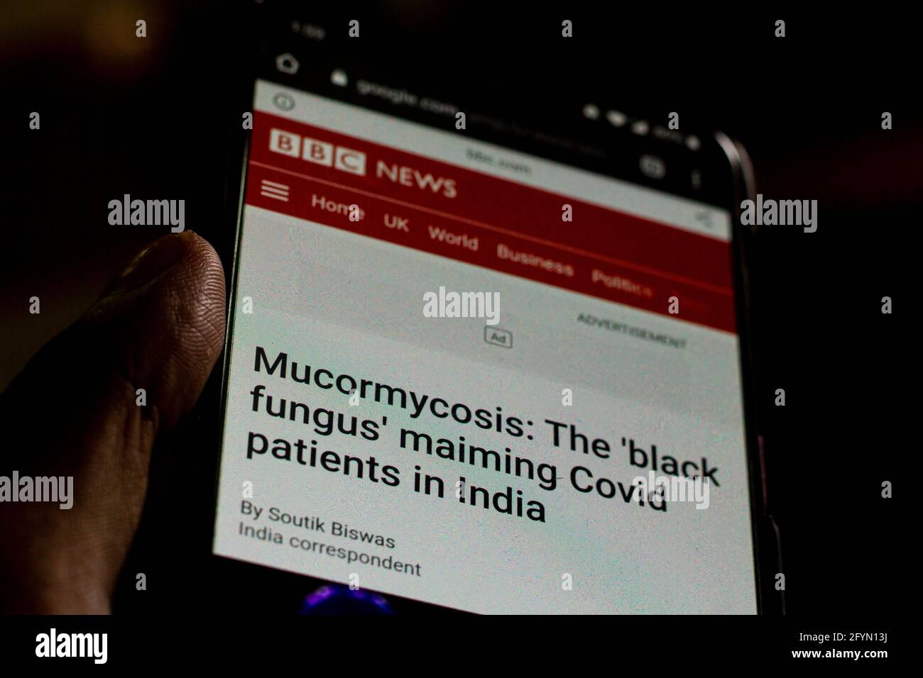 mucormycosis News on the phone.Mobile phone in hands. selective focus and chromatic aberration effects. Stock Photo