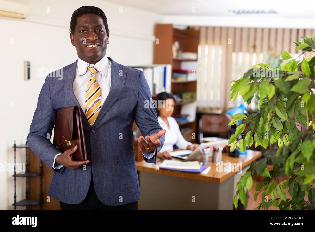 Confident smiling African American man in business suit standing in ...