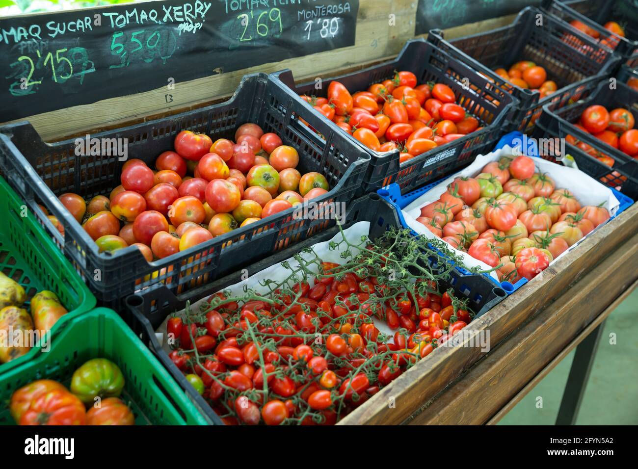 Boxes with ripe various tomatoes in grocery store Stock Photo - Alamy